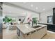 Bright, open kitchen featuring a large island with waterfall countertops and modern appliances at 2921 Newton St, Denver, CO 80211
