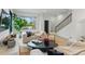 Inviting living room with neutral tones, cozy sofas, a modern console, and a view of the staircase at 2921 Newton St, Denver, CO 80211