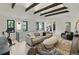 Spacious living room showcasing high ceilings, exposed beams, and a comfortable seating arrangement at 2921 Newton St, Denver, CO 80211
