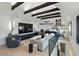 Modern living room with vaulted ceilings, exposed beams, and a large entertainment center at 2921 Newton St, Denver, CO 80211