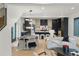 Open-concept living space featuring a dining area, cozy sofas, modern lighting, and a view into the kitchen at 2921 Newton St, Denver, CO 80211