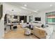Bright living space with large windows, modern furniture, stylish decor, and a glimpse into the kitchen area at 2921 Newton St, Denver, CO 80211
