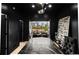 Contemporary office space features black walls, marble table, and open doors to the outdoor patio at 2921 Newton St, Denver, CO 80211