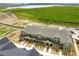 Breathtaking aerial view of townhouses and a scenic community, next to open land and water at 17123 W 91St Ln, Arvada, CO 80007