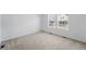 Empty bedroom with wall-to-wall carpet and natural light from the home's large windows at 17123 W 91St Ln, Arvada, CO 80007