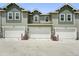 Townhome complex features individual garage and modern color schemes at 17123 W 91St Ln, Arvada, CO 80007