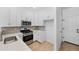 Modern kitchen featuring stainless steel appliances, white cabinetry, and sleek countertops at 17123 W 91St Ln, Arvada, CO 80007