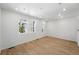 Bright living room featuring hardwood floors, ample natural light, and fresh white paint at 17123 W 91St Ln, Arvada, CO 80007