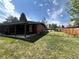 Spacious backyard with lush green lawn, mature trees, and a covered patio perfect for outdoor relaxation and entertaining at 5722 W Chestnut Ave, Littleton, CO 80128
