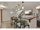Basement bar area showcasing counter seating, pendant lighting, and modern decor at 5722 W Chestnut Ave, Littleton, CO 80128