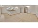 Spacious finished basement with neutral carpet, wood trim, and stairway to the upper level at 5722 W Chestnut Ave, Littleton, CO 80128