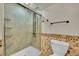 Modern bathroom with tiled shower and glass door, offering a spa-like experience at 5722 W Chestnut Ave, Littleton, CO 80128