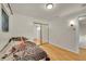 Cozy bedroom with hardwood floors, mirrored closet, and natural light at 5722 W Chestnut Ave, Littleton, CO 80128