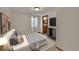 Bedroom featuring a bed, closet, bedside table, dresser and stylish decor at 5722 W Chestnut Ave, Littleton, CO 80128