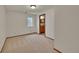 Bedroom with neutral carpet with a window and doorway to the bathroom at 5722 W Chestnut Ave, Littleton, CO 80128