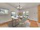 Charming dining area with hardwood floors, modern table setting, and bright natural light from the window at 5722 W Chestnut Ave, Littleton, CO 80128