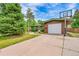 Exterior view of home featuring an attached garage with a basketball hoop and well-kept front yard at 5722 W Chestnut Ave, Littleton, CO 80128