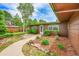 Charming single-story home boasts a welcoming front yard with mature trees and a stone walkway to the front door at 5722 W Chestnut Ave, Littleton, CO 80128