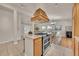 Kitchen featuring a range hood, granite counters, and an adjacent dining area at 5722 W Chestnut Ave, Littleton, CO 80128