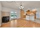 Open floor plan with kitchen, living, and dining room is great for entertaining and features a fireplace at 5722 W Chestnut Ave, Littleton, CO 80128