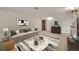 Living room with neutral-toned sofa, modern art, and a stylish coffee table on a rug at 5722 W Chestnut Ave, Littleton, CO 80128