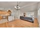 Open floor plan with kitchen, living, and dining room is great for entertaining and features vaulted ceilings at 5722 W Chestnut Ave, Littleton, CO 80128