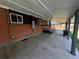 Covered patio with brick walls, showcasing ample space for outdoor gatherings and relaxation at 5722 W Chestnut Ave, Littleton, CO 80128