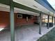Covered patio featuring brick walls and support beams offers a great outdoor space for relaxation and entertainment at 5722 W Chestnut Ave, Littleton, CO 80128
