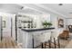 Stylish bar area with mirrored backsplash, sleek countertop, and comfortable seating at 7234 S Kendall Ct, Littleton, CO 80128