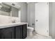 Neutral bathroom with a marble countertop and tile flooring and door at 7234 S Kendall Ct, Littleton, CO 80128