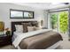 This is a bedroom featuring a brown bed and outdoor views at 7234 S Kendall Ct, Littleton, CO 80128
