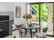 A modern dining area features hardwood floors, a round table, stylish chairs, and natural light at 7234 S Kendall Ct, Littleton, CO 80128