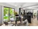 Dining area featuring a black table, four chairs, flowers and sliding glass doors to backyard at 7234 S Kendall Ct, Littleton, CO 80128