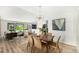 Open-concept dining area with modern decor, a stylish light fixture, and seamless flow at 7234 S Kendall Ct, Littleton, CO 80128