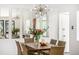 Bright dining area with a stylish light fixture, modern decor, and ample seating at 7234 S Kendall Ct, Littleton, CO 80128