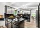 Modern kitchen featuring sleek stainless steel cabinets, black backsplash, and tiled countertops at 7234 S Kendall Ct, Littleton, CO 80128
