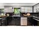 Close up on the kitchen featuring stainless steel cabinets, appliances, and black tiled countertops at 7234 S Kendall Ct, Littleton, CO 80128