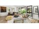 Stylish living room with modern decor, large windows, and ample natural light at 7234 S Kendall Ct, Littleton, CO 80128