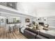 Open-concept living room with fireplace, modern bar and light wood floors at 7234 S Kendall Ct, Littleton, CO 80128