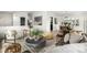 Open-concept living space with modern furniture, stylish decor, and bright lighting at 7234 S Kendall Ct, Littleton, CO 80128