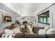Bright living room with vaulted ceilings, fireplace, large windows, and comfortable seating at 7234 S Kendall Ct, Littleton, CO 80128