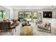 Bright living room featuring modern furniture, large windows, and stylish decor at 7234 S Kendall Ct, Littleton, CO 80128