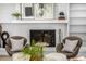 Cozy living room featuring a white brick fireplace and comfortable seating at 7234 S Kendall Ct, Littleton, CO 80128