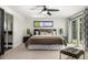 Spacious main bedroom with plush bedding, and access to a private balcony at 7234 S Kendall Ct, Littleton, CO 80128