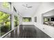 Bright sunroom featuring black tile floors and large windows with backyard views at 7234 S Kendall Ct, Littleton, CO 80128