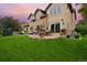Lush backyard with a stone patio, outdoor furniture and a grill at 14370 Osage St, Westminster, CO 80023