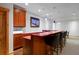 Basement wet bar with wood cabinets and stylish lighting at 14370 Osage St, Westminster, CO 80023