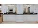 Double vanity with black countertop, white cabinets and decorative lighting, offering ample space and modern elegance at 14370 Osage St, Westminster, CO 80023