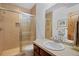 Well-lit bathroom featuring a tiled shower with glass door at 14370 Osage St, Westminster, CO 80023