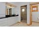 Elegant bathroom boasting black countertops, white cabinets, glass shower and a walk in shower at 14370 Osage St, Westminster, CO 80023